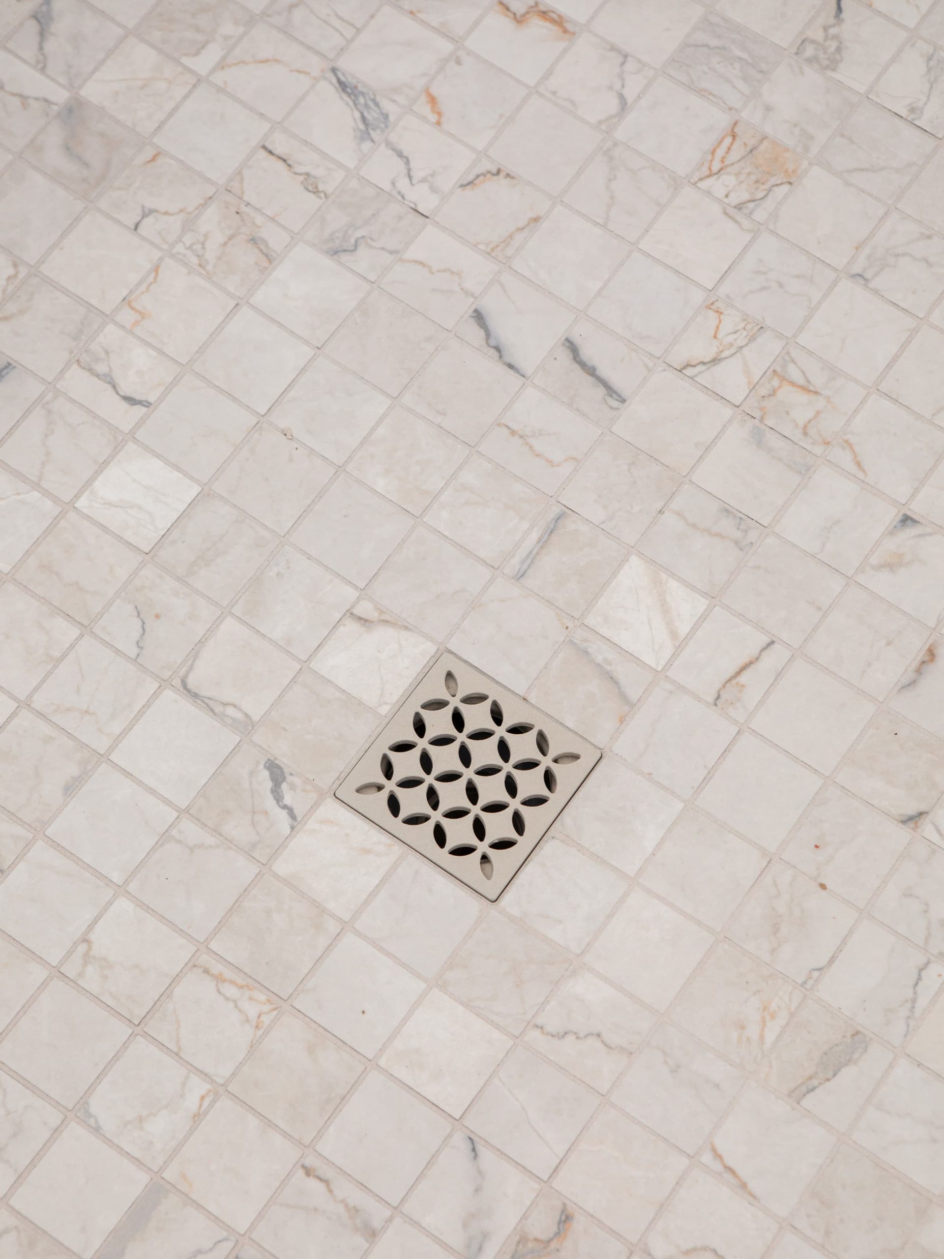 white tiled floor with drain